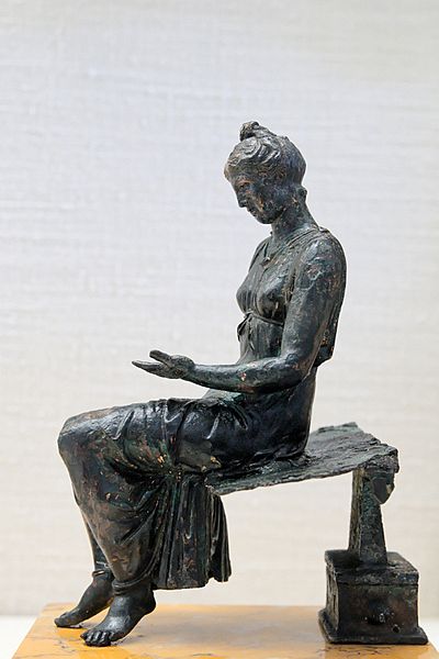 Bronze statue of a young girl reading