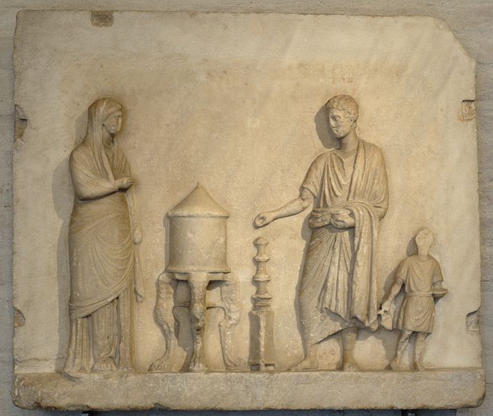 A relief of a slave helping a priestess to make a religious sacrifice 