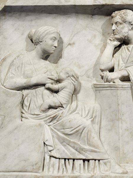 Relief of a wife breastfeeding her child in front of her husband 